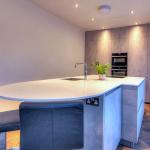 handleless Keller concrete-look kitchen with quartzstone worktop