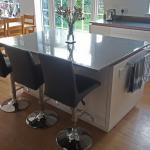 High gloss kitchen island with quartz worktop sized to create a breakfast bar for 3