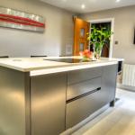 Handleless centre island with soft-close pan drawers and integrated freezer.