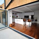 contemprary fitted kitchen with island and bifold doors