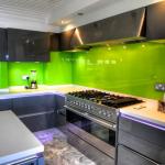handleless high gloss fitted kitchen with glass splashbacks