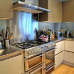 Stainless steel worktops compliment the appliances and provide a good contrast to the matte kitchen units