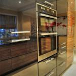 Tall housings with high gloss black lacquer doors and Kuppersbusch black and steel double oven.