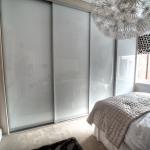 Fitted bedrooms White glass sliding door robes