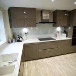 Handleless gloss fitted kitchen in Lytham St Annes with Corian work surfaces and Amtico flooring