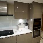 Handleless gloss fitted kitchen in Lytham St Annes with Corian work surfaces and Neff appliances