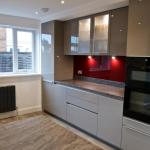 Keller gloss kitchen featuring a Neff built in double oven