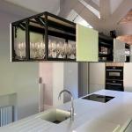 open wall units suspended over the island provide storage without blocking a lot of light
