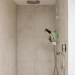 Porcelain tiled walk-in shower area with Mira shower
