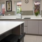 Family kitchen handleless with sharknose edged Corian tops and a mix of gloss and matt doors