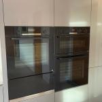 suite of Bosch ovens and a warming drawer built into tall housings