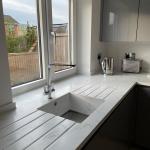 solid surface sink with stainless steel bottom and drainer grooves on both sides
