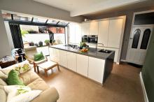 Fitted kitchen with bi-fold doors and island.